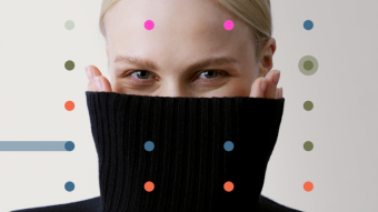 A person wearing a black turtleneck sweater colourful dots on the foreground